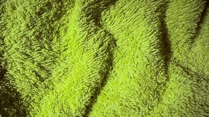  textured lime green towel fabric background for web design, product packaging, spa branding, print...