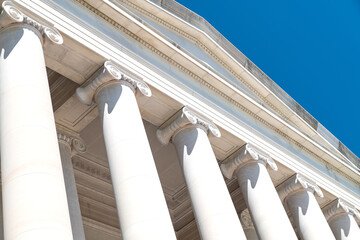 historical building design with decorative stone columns. View from below.
