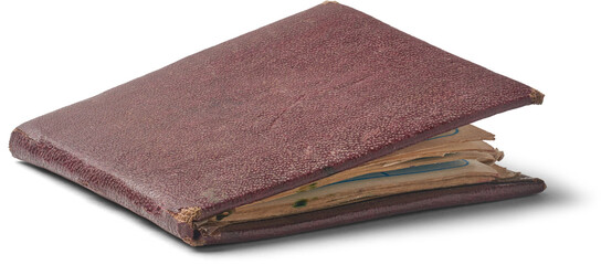 close-up of closed rectangular phone book isolated white background, worn dark reddish brown leather cover with fraying and discoloration and yellowish pages