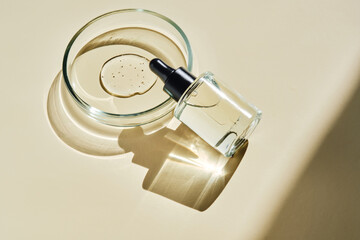 Oil essence for the face on a beige background.