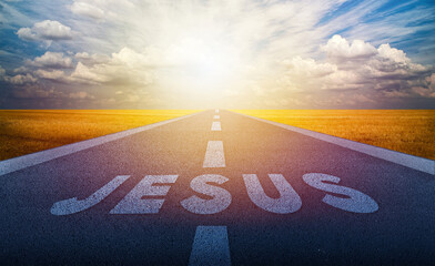 Jesus name on the road in the middle of asphalt road with at sunset forward. Faith and heaven concept