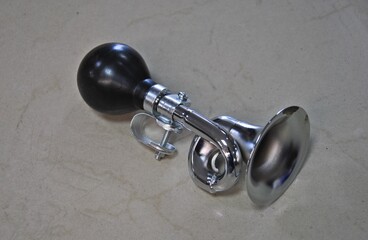 Chromed bicycle air horn in retro style on a dark background