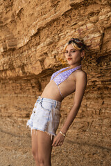 Young woman posing at la mina beach in paracas national reserve
