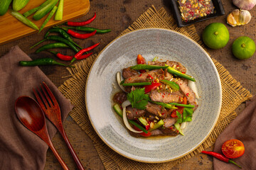 Spicy Grilled beef with Cucumber Salad,grilled meat with onion and sliced cucumber in chilli lime sauce.(Yum Neua Yang).Top view