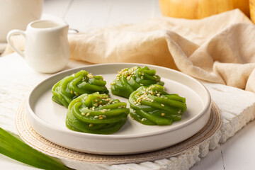 Pandan Coconut Sweets Pudding with sesame in white plate,Thai dessert.(Kanom Piakpoon)