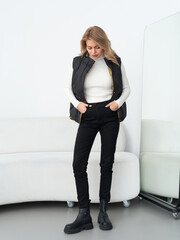 Stylish model poses gracefully in a modern studio showcasing contemporary fashion trends