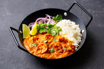 Spicy Shrimp Curry with Rice and Garnish. Grey background. Close up.