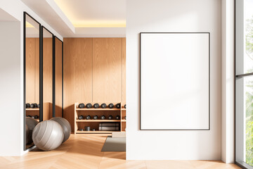 Poster mockup in modern home gym interior with wooden walls, fitness equipment, large windows and bright daylight ambiance. 3D Rendering. 3D Rendering