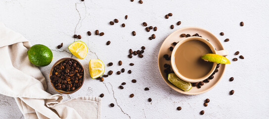A cup of latte infused with lime on the table top view web banner