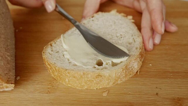 Butter on toast. Healthy appetizer. Scene on a wooden board.