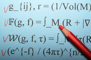 Mathematical exploration with red pencil on blue worksheet during study session