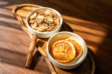 honey dripping from a white spoon and orange dried