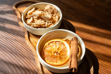 honey dripping from a white spoon and orange dried