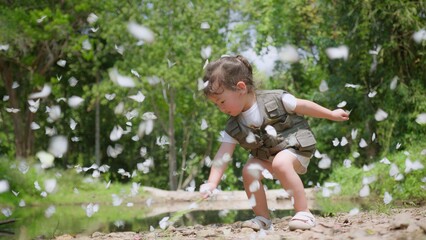 A young Asian child girl Enjoying Nature plays joyfully among butterflies in a Lush Green Forest, capturing the essence of nature and innocence.