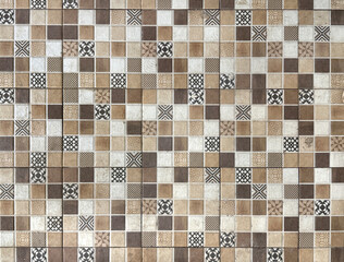 Close up of decorative floral brown and beige mosaic tiles. Dark brown metallic mosaic tiles are symbol of luxury and elegance, usually used in bathroom, kitchen, or luxurious hotel.