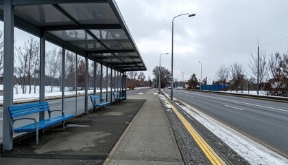 Empty bus stop with benches on a cold winter day in the city