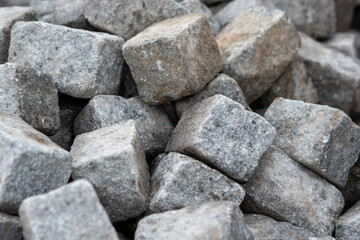 Square brick pile, Ceramic sewer pipe laid on construction site, close-up view of bricks, background brick texture