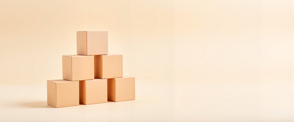 Obraz premium Cubes forming a pyramid structure on soft neutral backdrop, creativity