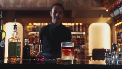 Focusing in serving mist smoky classical mixing whiskey cocktail presentation cooling textured, recommending special welcome tasty creative by bartender background at beverage counter bar. Vinosity.