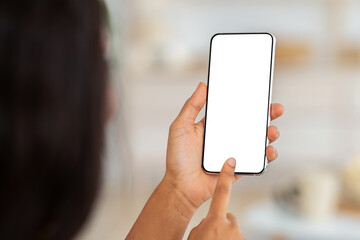 Working or studying from home remotely. African American woman touching mobile phone screen with mockup for mobile app or website design, indoors. Black lady using modern gadget