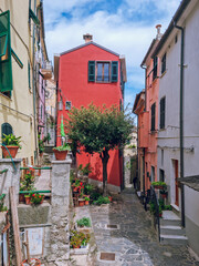 Obraz premium Court with flowers between colorful houses in Porto Venere, best boat trip from La Spezia, Liguria, Italy