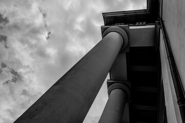 Imposing columns reach toward the overcast sky in a dramatic architectural landscape