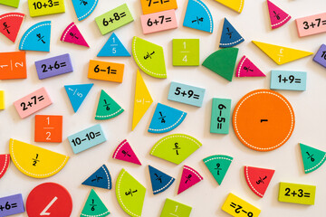 Colorful math manipulatives scattered on a white surface for hands-on learning and educational activities