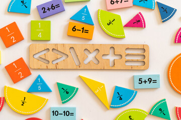 Colorful wooden math manipulatives arranged creatively on a table for educational activities in a...