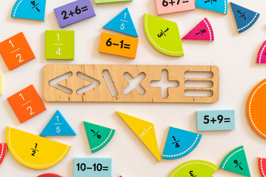 Colorful wooden math manipulatives arranged creatively on a table for educational activities in a home or classroom setting
