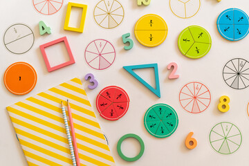 Colorful educational materials for teaching basic geometry and mathematics on a vibrant workspace....