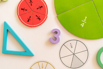 Learning tools displayed on a table for hands-on math activities in a classroom setting during a sunny afternoon