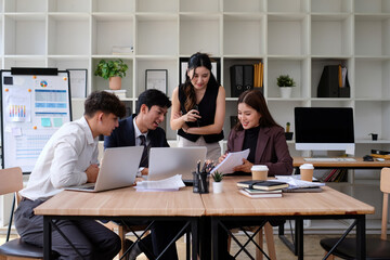 Several business teams are meeting in the office and sharing their ideas for success.