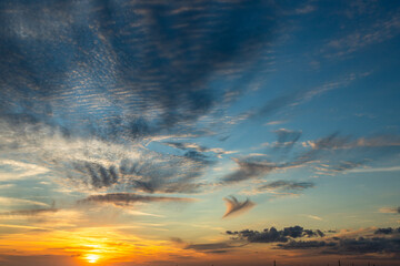 A dramatic set of clouds, at sunset, drifting over the tropical waters of the Caribbean Sea are lit...