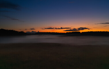 Sunset in the Latvian countryside over meadows and forests in Latgale.