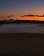 Obraz premium Sunset in the Latvian countryside over meadows and forests in Latgale.