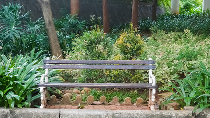 Secluded garden bench surrounded by lush greenery and a peaceful ambiance