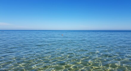 Obraz premium Sea with Clear Water Under a Blue Sky