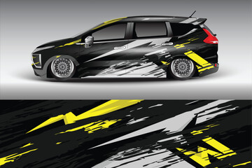 Stylish black car with dynamic yellow graphics on road