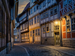 Fototapeta premium Cobblestone street at twilight with traditional German half-timbered houses