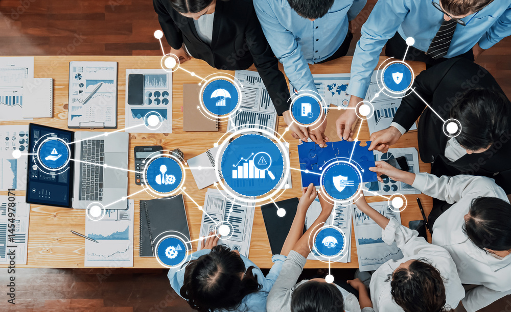 Poster a diverse business team working together at a table filled with graphs and data. the image illustrat