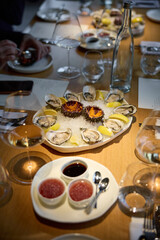 Champagne tasting, Wine glasses are on the table, stylish table setting, sparkling wine bubbles, oysters and sea urchins, special sauce