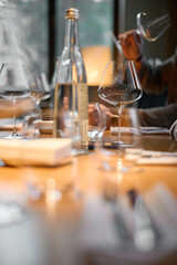Champagne tasting, Wine glasses are on the table, stylish table setting, A man's hand holds a beautiful elegant glass with rose sparkling wine, an intimate light, a plate with oysters and lemon