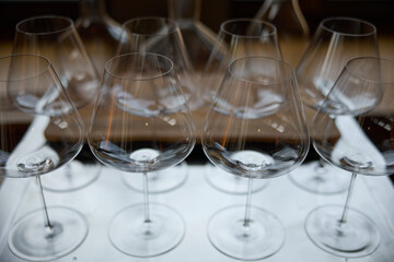 Clean wine glasses are on the table of a special wine cabinet, stylish table setting, ice, bottle of sparkling wine, light from window, decanter and degasser
