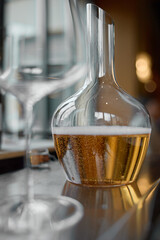 Decanter for sparkling wine on the table, Champagne tasting, Wine glasses, reflections, rose wine