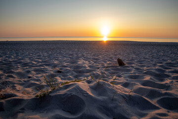 Stunning sunset over the Baltic Sea on the Darß Peninsula in Germany creating a serene atmosphere for beachgoers