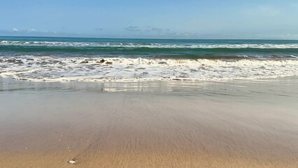 Experience the serene beach waves at sunset, creating a blissful moment of peace and tranquility