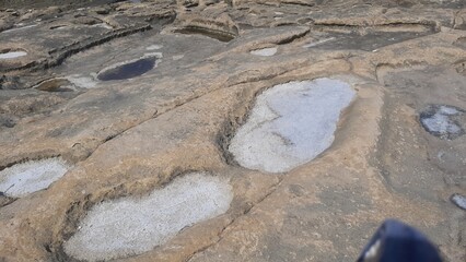 Natural rock formations with salt deposits in a rocky landscape  
