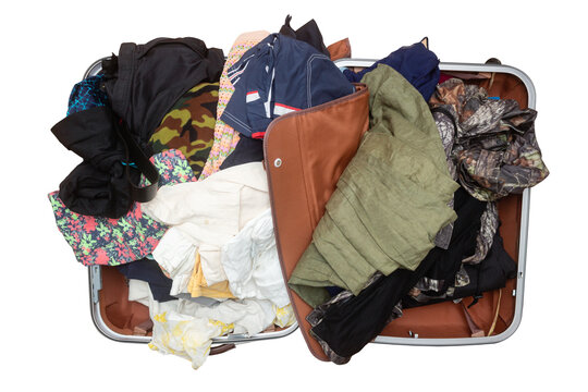 Open suitcase with belongings and clothes isolated on white background. Top view