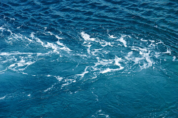 Rippled and foamy turquoise deep sea water aerial view
