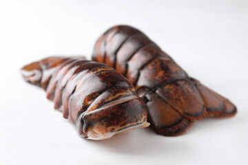 Raw lobster tails on white table, closeup